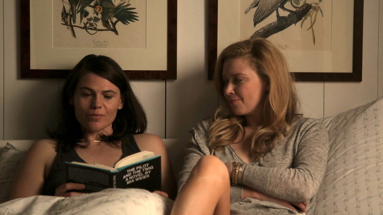 Natasha Lyonne sitting next to Clea DuVall in bed in The Intervention