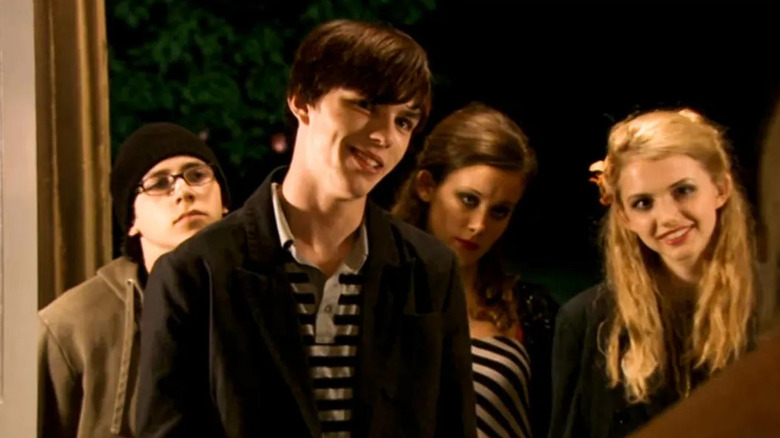 Nicholas Hoult as Tony Stonem smmirking in a doorway in Skins.