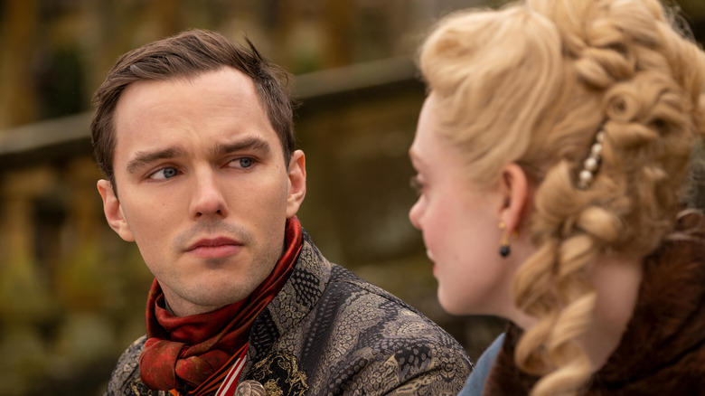 Nicholas Hoult as Peter III looks at Elle Fanning as Catherine the Great in The Great.