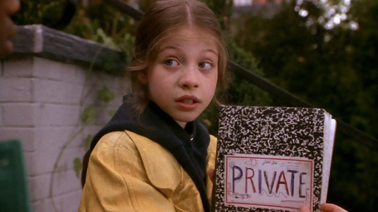 Michelle Trachtenberg as Harriet M. Welsch, holding her private notebook in Harriet the Spy