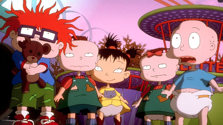 The Rugrats look up at something in a theme park in Rugrats in Paris