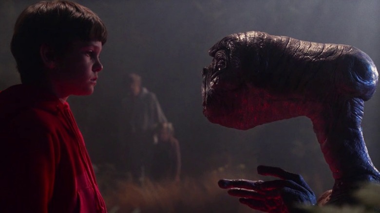Henry Thomas as Elliott Taylor and E.T. looking at each other in E.T. the Extra-Terrestrial