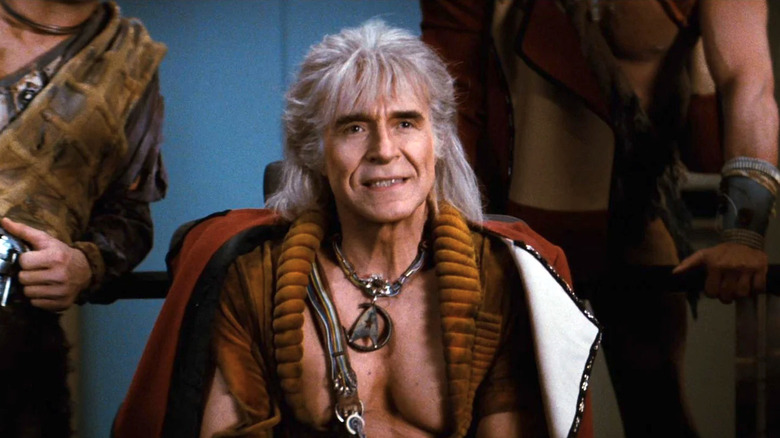Khan Noonien Singh(Ricardo Montalbán) sits smugly in a captain's chair in Star Trek II: The Wrath of Khan