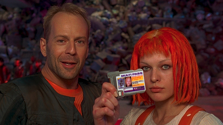 Korben Dallas (Bruce Willis) and Leeloo (Milla Jovovich) present their multipasses in The Fifth Element