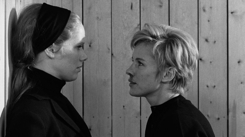 Bibi Andersson as Alma and Liv Ullmann as Elisabet Vogler in Persona, with Elsabet looking into Alma's eyes as she's backed into a wall.