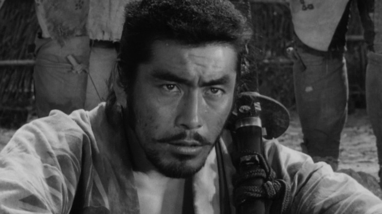 Toshiro Mifune as Kikuchiyo in Seven Samurai, looking dramatically past the frame.