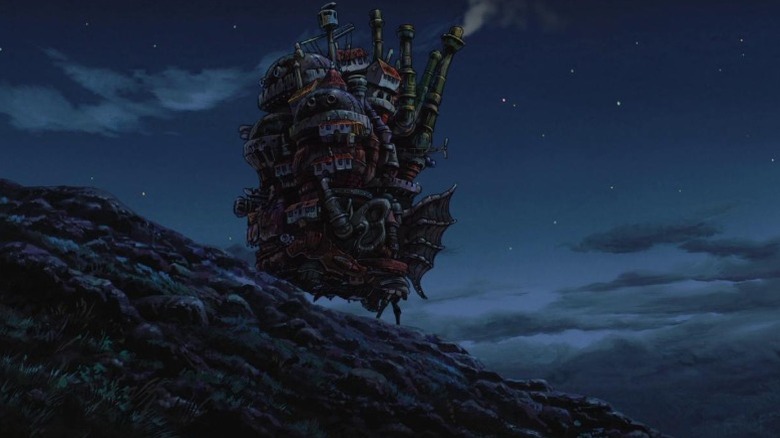 Howl's moving castle perched on a rocky slope at night in Howl's Moving Castle