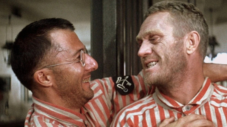 Dustin Hoffman as Dega and Steve McQueen as Papillon, happy to see each other again in Papillon