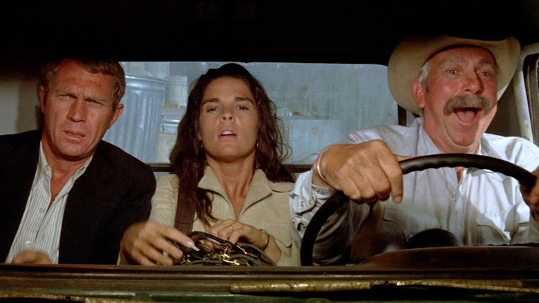 Steve McQueen as Doc, Ali McGraw as Carol, and Slim Pickens as Cowboy, driving to Mexico in The Getaway