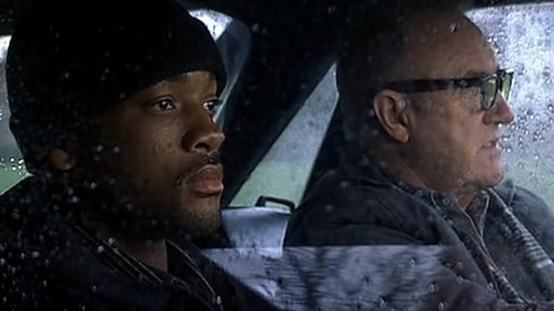 Will Smith as Robert Clayton Dean and Gene Hackman as Edward Lyle / Brill in Enemy of the State, driving in a car in the rain