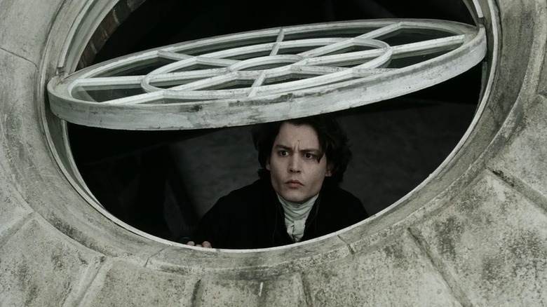 Ichabod Crane (Johnny Deep) peering out a window in Sleepy Hollow