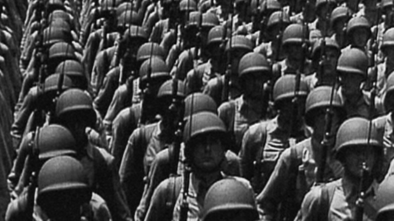 American soldiers stand in formation with fixed bayonets in Five Came Back