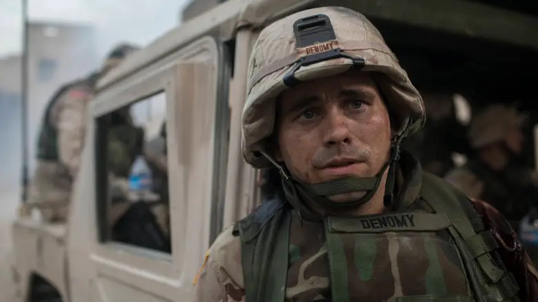 Troy Denomy (Jason Ritter) stands by his Humvee in The Long Road Home