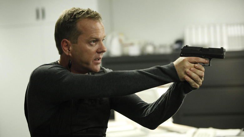 Kiefer Sutherland as Jack Bauer pointing a gun off-camera in 24