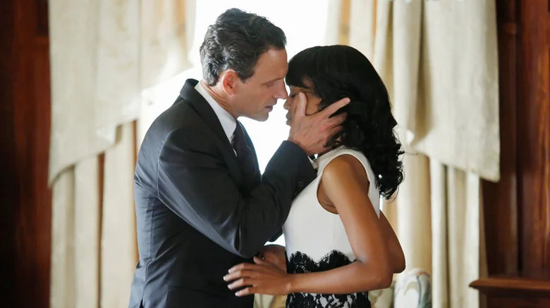 Tony Goldwyn as President Grant leaning in to kiss Kerry Washington as Olivia Pope with hands on her face in Scandal