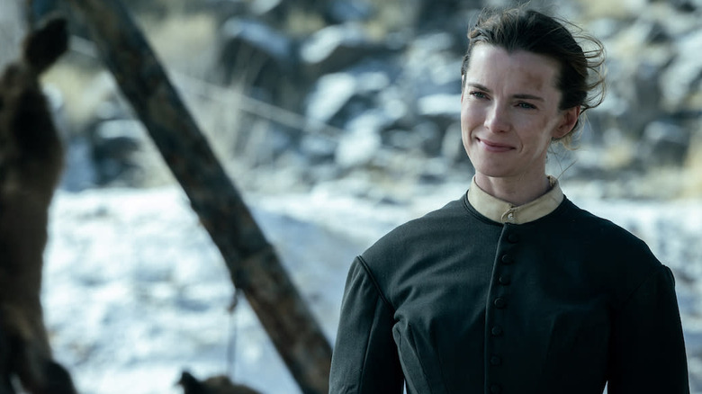 Betty Gilpin as Sara standing outside in American Primeval