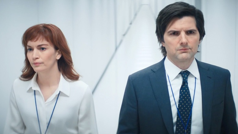 Britt Lower and Adam Scott as Helly and Mark walking down the hall in Severance