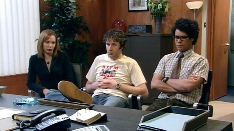 Katherine Parkinson, Chris O'Dowd, Richard Ayoade as Jen, Roy, and Maurice sitting together in The IT Crowd