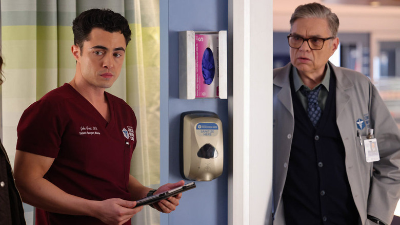 Dr. John Frost (Darren Barnet) and Dr. Daniel Charles (Oliver Platt) looking into room on Chicago Med