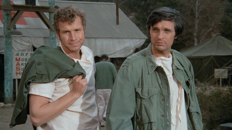 Hawkeye (Alan Alda) and Trapper John (Wayne Rogers) at their camp on M*A*S*H