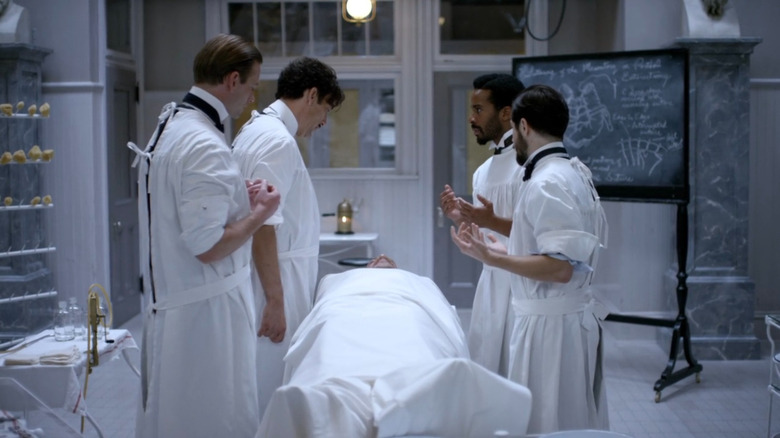 Dr. John Thackery (Clive Owen) and other doctors looking at patient on The Knick