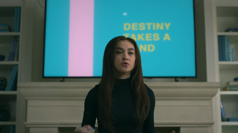 Kitty (Anna Cathcart) standing in front of powerpoint presentation in XO Kitty