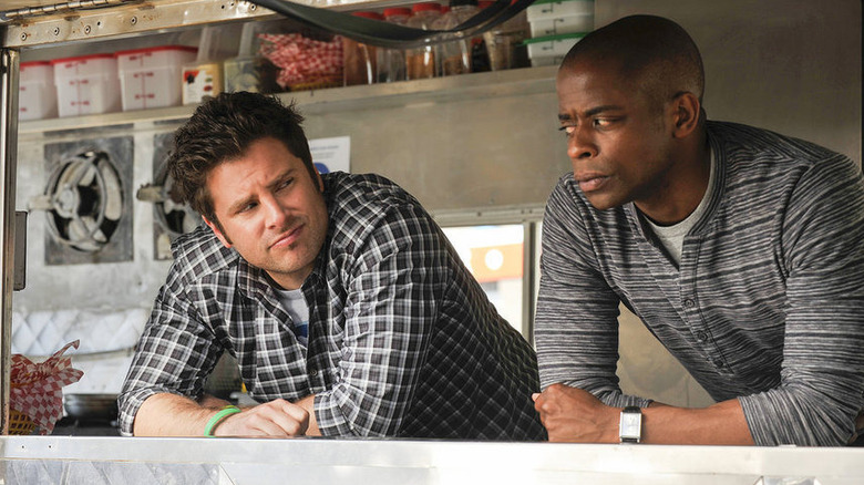 Shawn Spencer (James Roday Rodriguez) and Gus Guster (Dulé Hill) eye each other while leaning on a kitchen counter on Psych