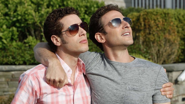 Evan Lawson (Paulo Costanzo) and Hank Lawson (Mark Feuerstein) put their arms around each other while looking up with sunglasses on Royal Pains