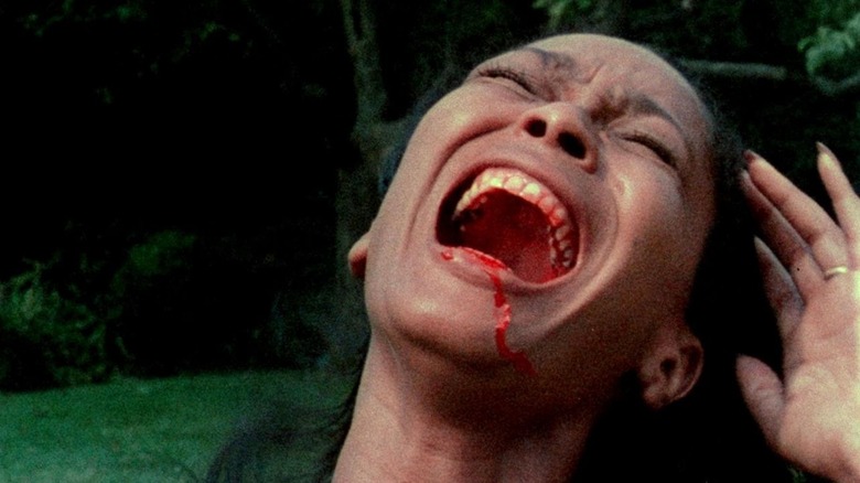 Ganja Meda (Marlene Clark) screaming in pain while blood drips down her mouth in Ganja & Hess (1973).