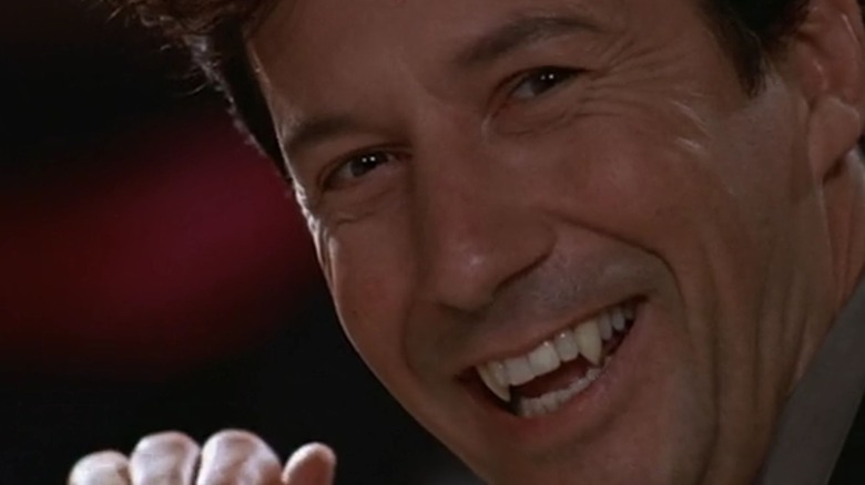 Dimitri Dentatos (Charles Shaughnessy) smiling menacingly with his fangs out in Mom's Got a Date with a Vampire (2000).