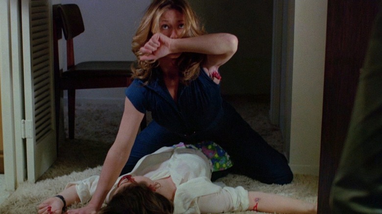 Rose (Marilyn Chambers) reveals her armpit stinger whilst atop her latest victim in Rabid (1977).