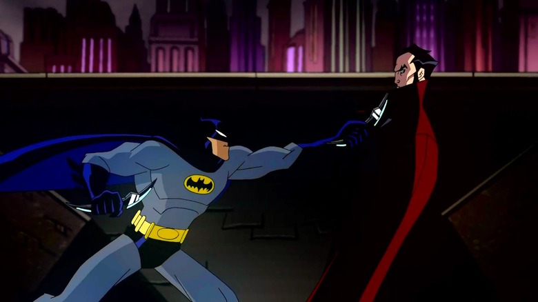 Batman (voiced by Rino Romano) double fists his batarangs while fighting Dracula (voiced by Peter Stormare) in The Batman vs. Dracula (2005).