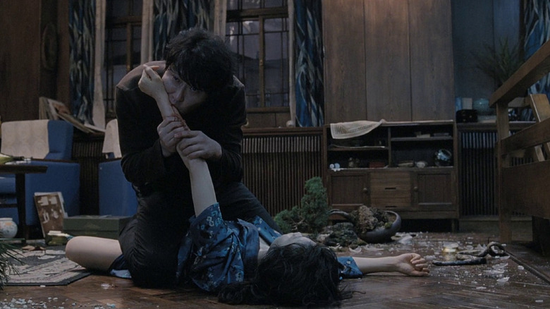 Priest Sang-hyeon (Song Kang-ho) bites into his lover Tae-ju's (Kim Ok-vin) arm in Thirst (2009).