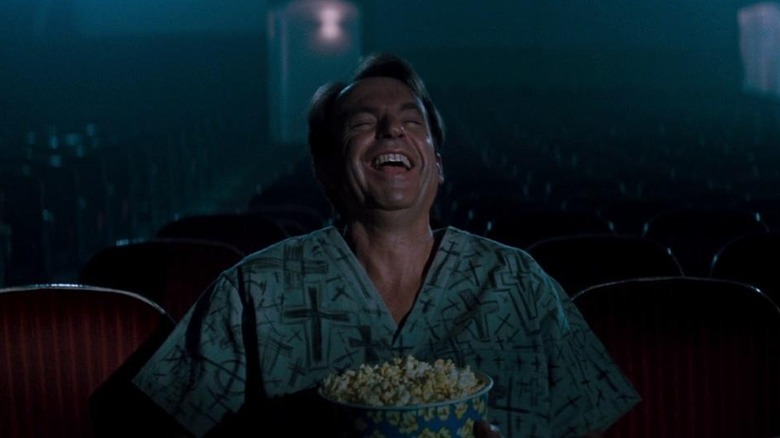 John Trent (Sam Neill) laughs in In The Mouth of Madness