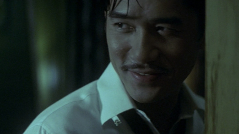 Chow (Tony Leung) smiles in 2046