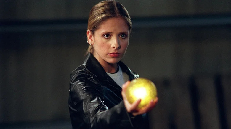 Sarah Michelle Gellar as Buffy holding a glowing orb in Buffy the Vampire Slayer
