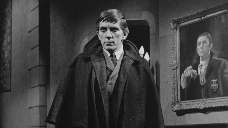 Jonathan Frid as Barnabas Collins standing in front of his portrait in Dark Shadows