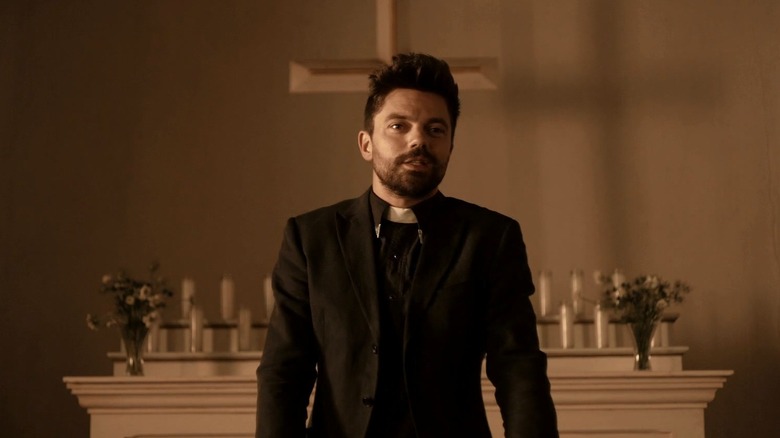 Dominic Cooper as Jesse Custer wearing a black preacher outfit in Preacher