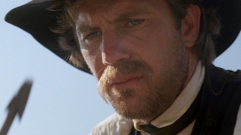 John Dunbar (Kevin Costner) contemplatively holds an arrow in Dances with Wolves