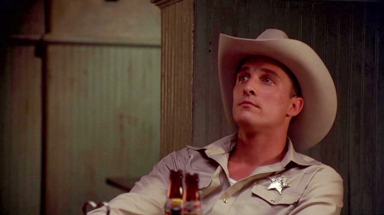 Buddy Deeds (Matthew McConaughey) sits pensively looking up in his sheriff uniform in Lone Star (1996)