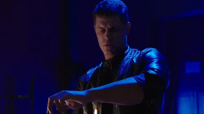 Cody Rhodes as Derek Sampson looking down at his arm in Arrow