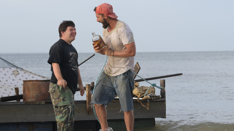 Zak (Zack Gottsagen) and Tyler (Shia LaBeouf) go rafting in The Peanut Butter Falcon
