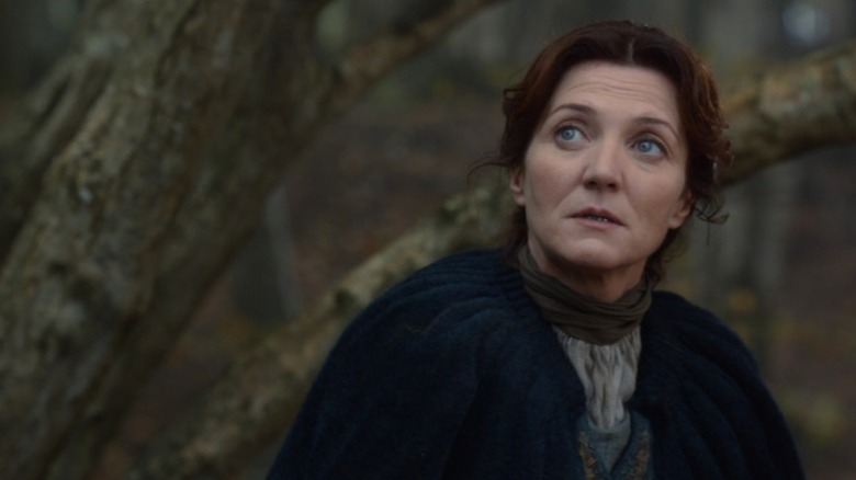 Michelle Fairley as Catelyn Stark in the woods in Game of Thrones