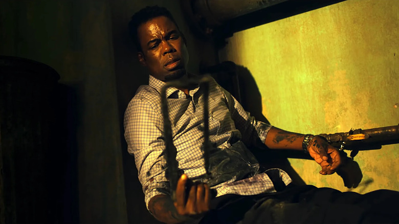 Chris Rock as Detective Zeke Banks is chained to a pipe in Spiral: From the Book of Saw
