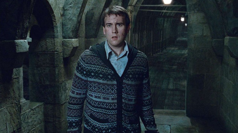 Matthew Lewis as Neville Longbottom stands in a hallway in Harry Potter and the Deathly Hallows