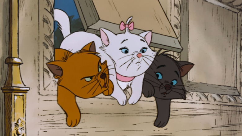 Toulouse, Marie, and Berlioz trying to squeeze through a doggie door in The Aristocats