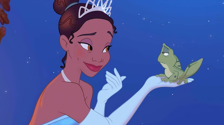 Tiana holding a frog in The Princess and the Frog