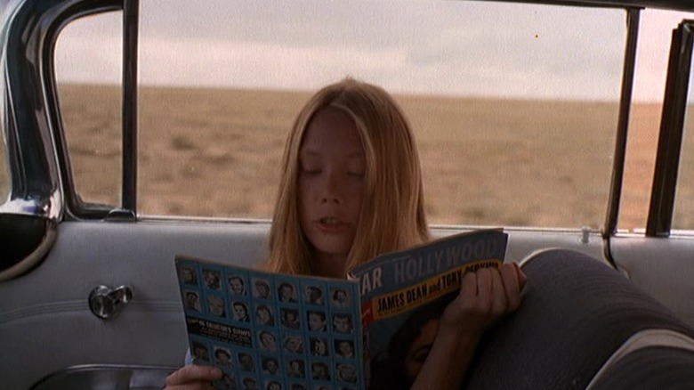 Sissy Spacek as Holly sitting in the car passenger's seat and reading a magazine in Badlands