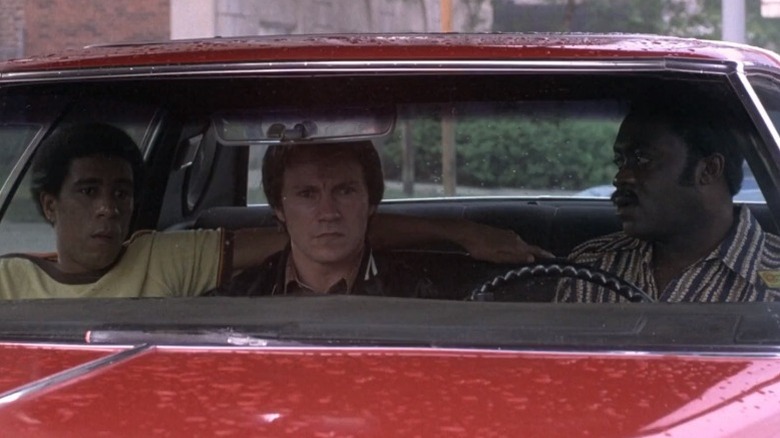 Richard Pryor as Zeke, Harvey Keitel as Jerry, and Yaphet Kotto as Smokey sitting in a car in Blue Collar