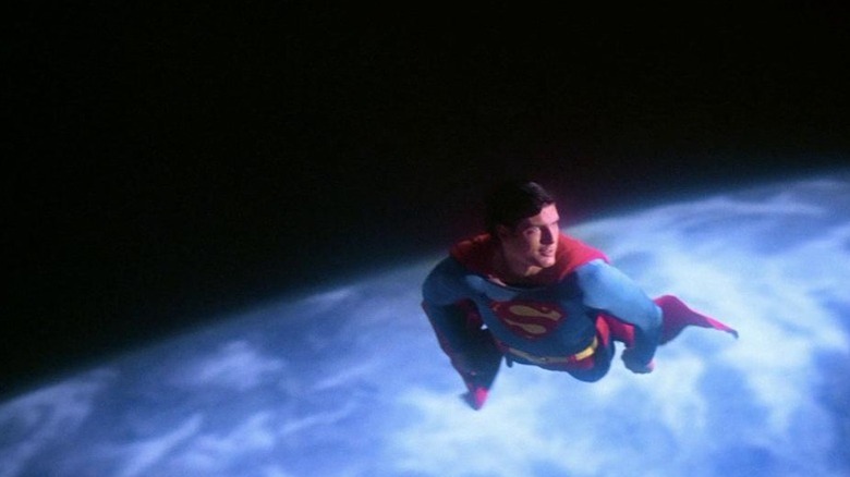 Christopher Reeve as Superman flying through space in the Earth's orbit in Superman